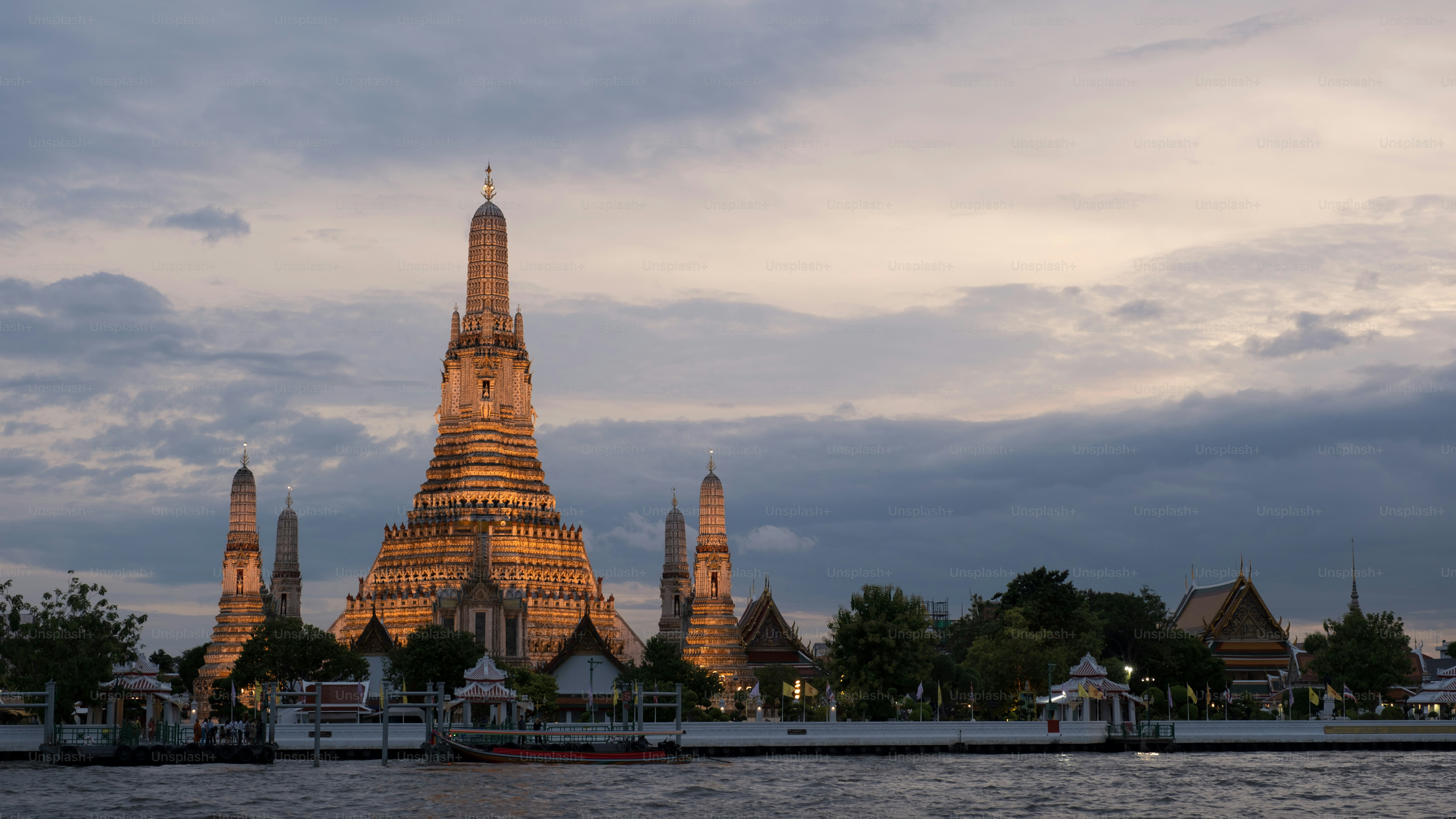 a very tall building sitting on the side of a river